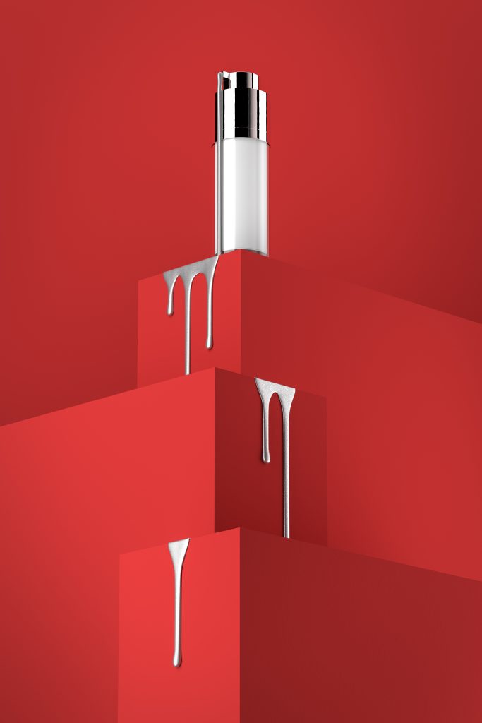 cream beauty packaging dripping silver fluid over red cubes